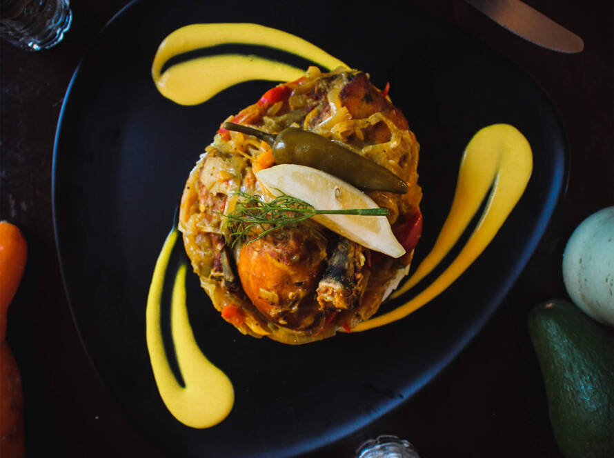 A plate of food with some yellow and black sauce on it