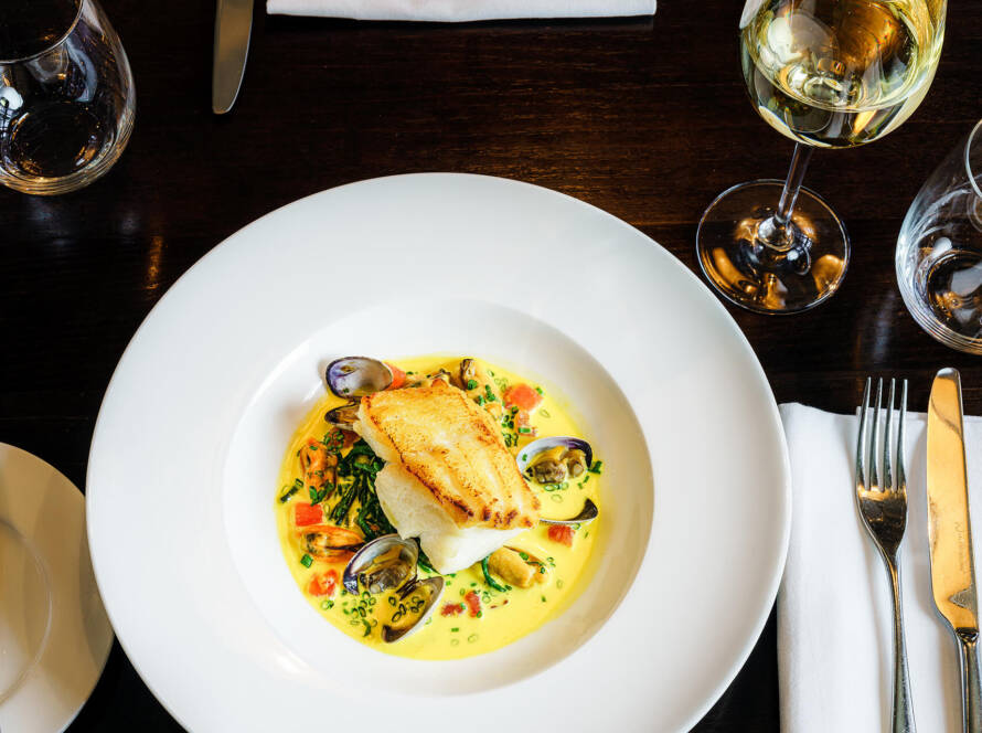 A white plate topped with food on top of a table.